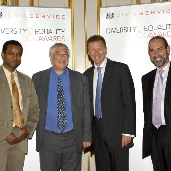 Winning an Award at the National Civil Service Equality and Diversity Awards ceremony in 2006.  From left to right: BBC Reporter Rageh Omaar, John Flanner MBE, Sir Gus Oâ€™Donnell, and former HMRC Chairman, Paul Gray.